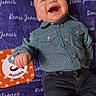 Remi is registered to the contest to win money with this photo: baby, blanket, blue_eyes, card, celebration, child, clothing, cute, happy, indoor, infant, jeans, joyful, lying_down, months, patterned_clothing, portrait, shirt, smiling, text