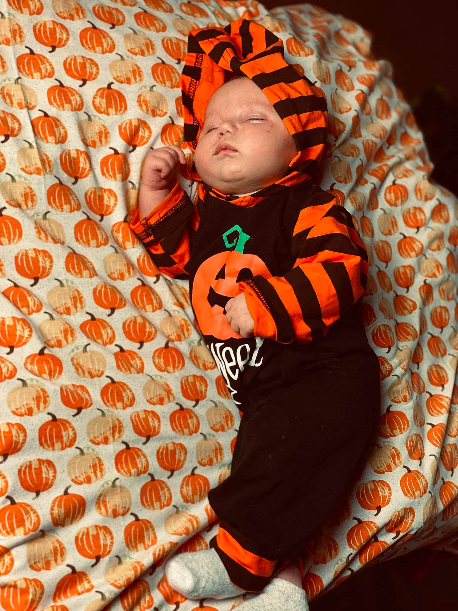 Booker is registered to the contest to win money with this photo: baby, baby_sleeping, baby_toddler_clothing, carpet, child, comfort, design, flooring, fun, happy, linens, orange, outerwear, pattern, peach, person, product, sleeve, t_shirt, textile
