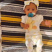 A'Millioán is registered to the contest to win money with this photo: adorable, baby, bow, child, clothing, comfort, cute, duck, headband, indoors, infant, lying_down, pacifier, pajamas, plush_toy, portrait, resting, soft_toy, striped_blanket, young_child