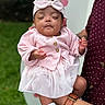 Lauryn joined the competition — help win amazing prizes! baby, infant, child, pink_outfit, headband, bow, sleeping, closed_eyes, hand, adult_hand, watch, maroon_shirt, dots, grass, outdoor, nature, portrait, cute, toddler, holding