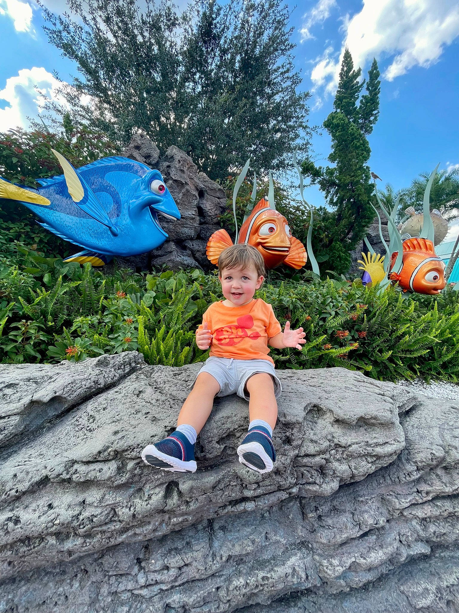 Finnley is registered to the contest to win money with this photo: azure, cloud, electric_blue, fun, garden, grass, happy, hat, joy, landscape, lawn_ornament, leaf, leisure, people_in_nature, person, plant, public_space, recreation, shorts, sky