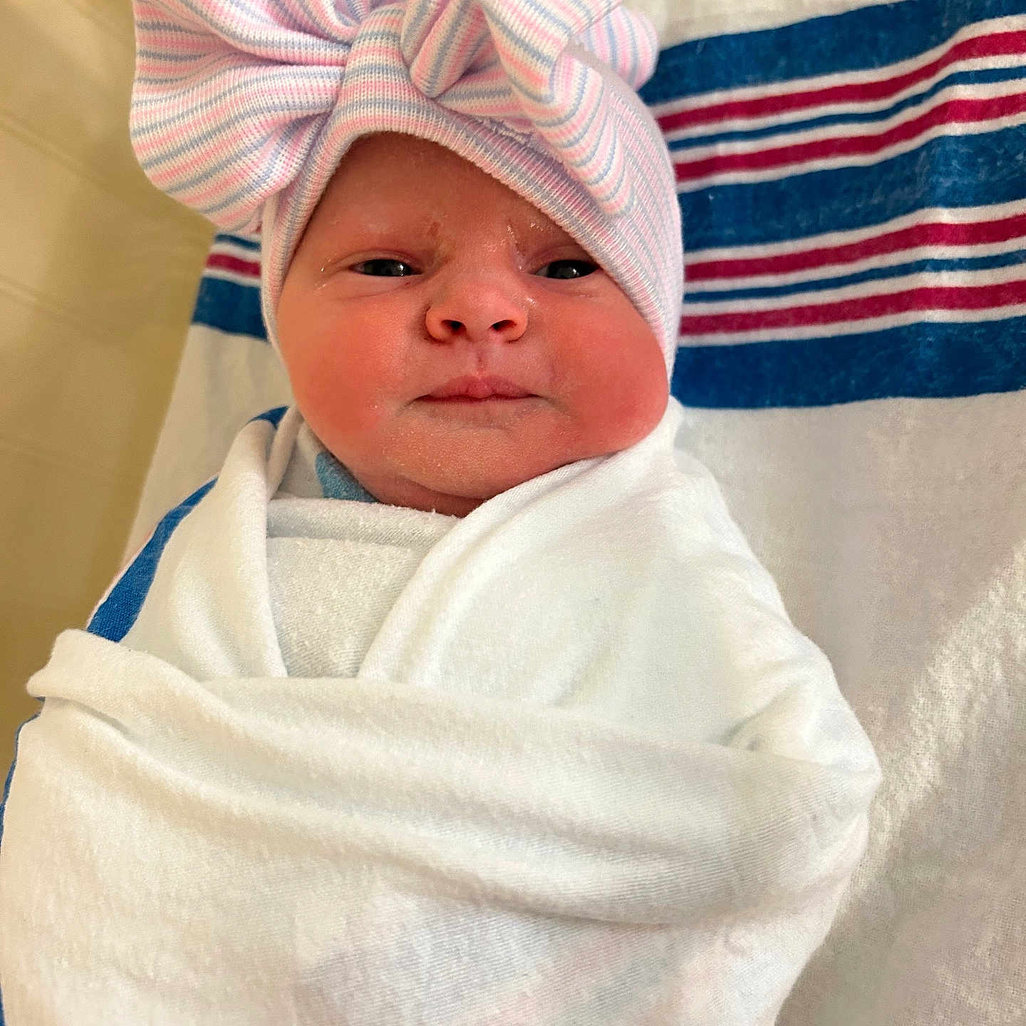 Maddie Mae is registered to the contest to win money with this photo: americanflag, baby, blanket, bonnet, cap, clothing, face, flag, formalwear, hat, head, hood, newborn, person, photography, portrait, quilt, towel, turban