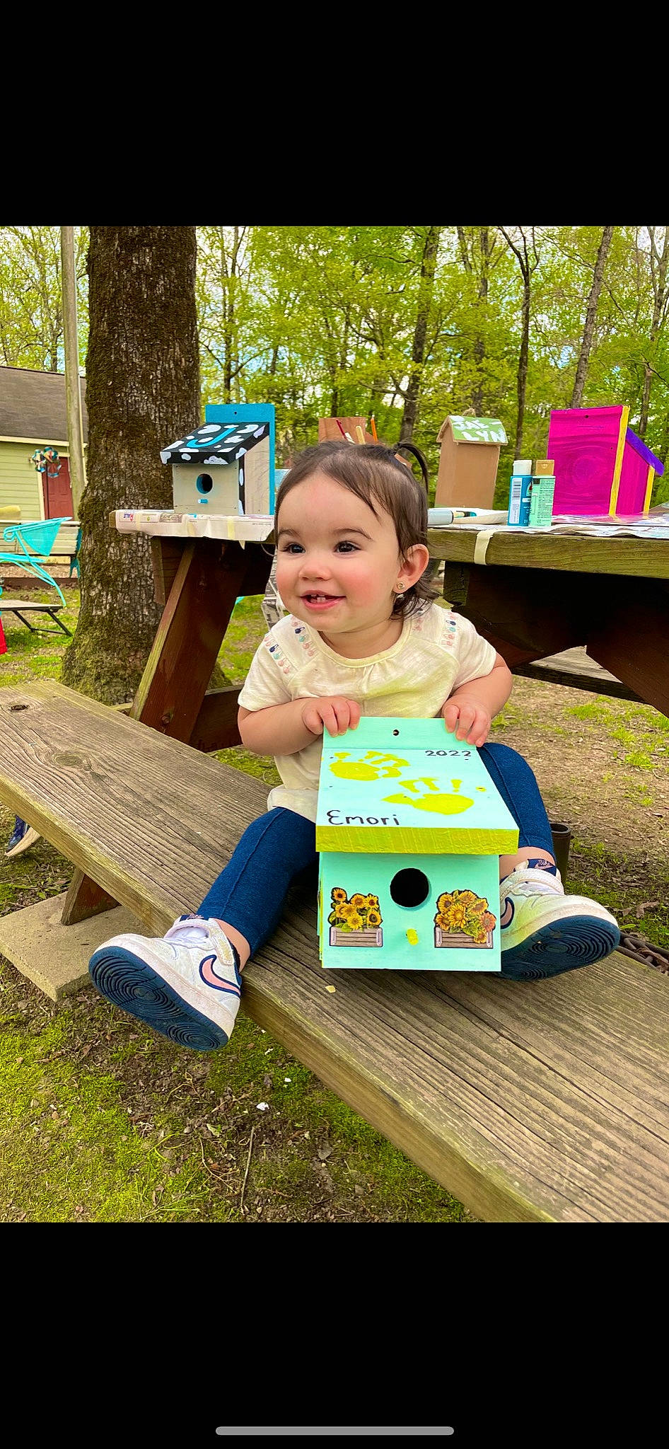 Emori is registered to the contest to win money with this photo: chair, child, fun, grass, green, happy, jeans, joy, leisure, nature, outdoor_furniture, people_in_nature, person, plant, public_space, recreation, smile, t_shirt, table, toddler