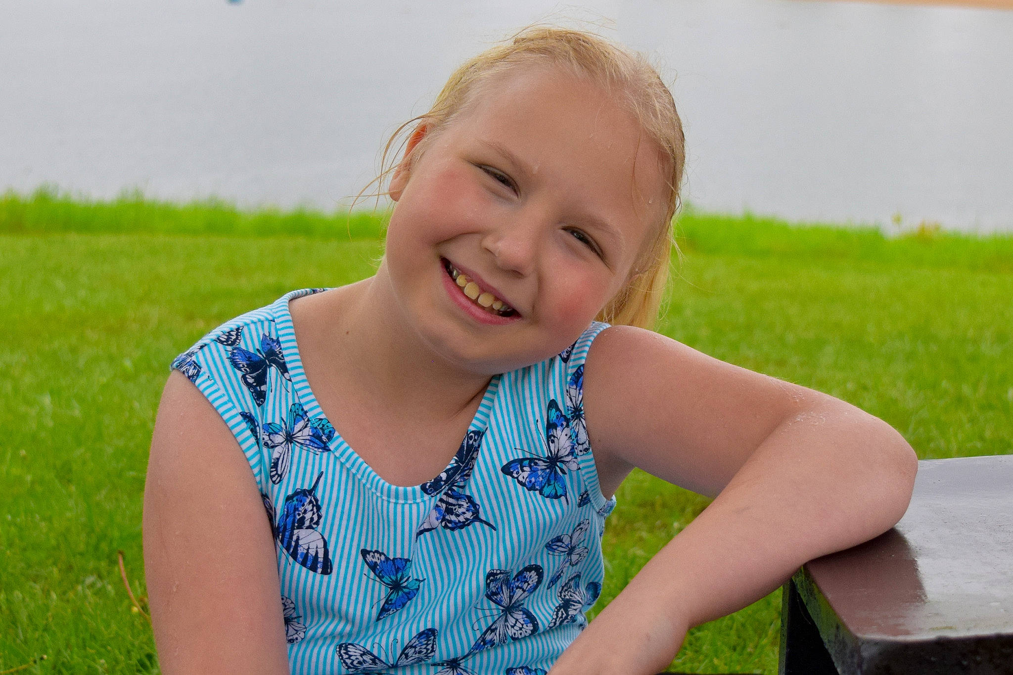 Kelsey joined the competition — help win amazing prizes! blond, child, facial_expression, fun, grass, grass_family, happy, joy, lawn, leisure, meadow, person, photography, plant, sitting, skin, smile, summer, vacation