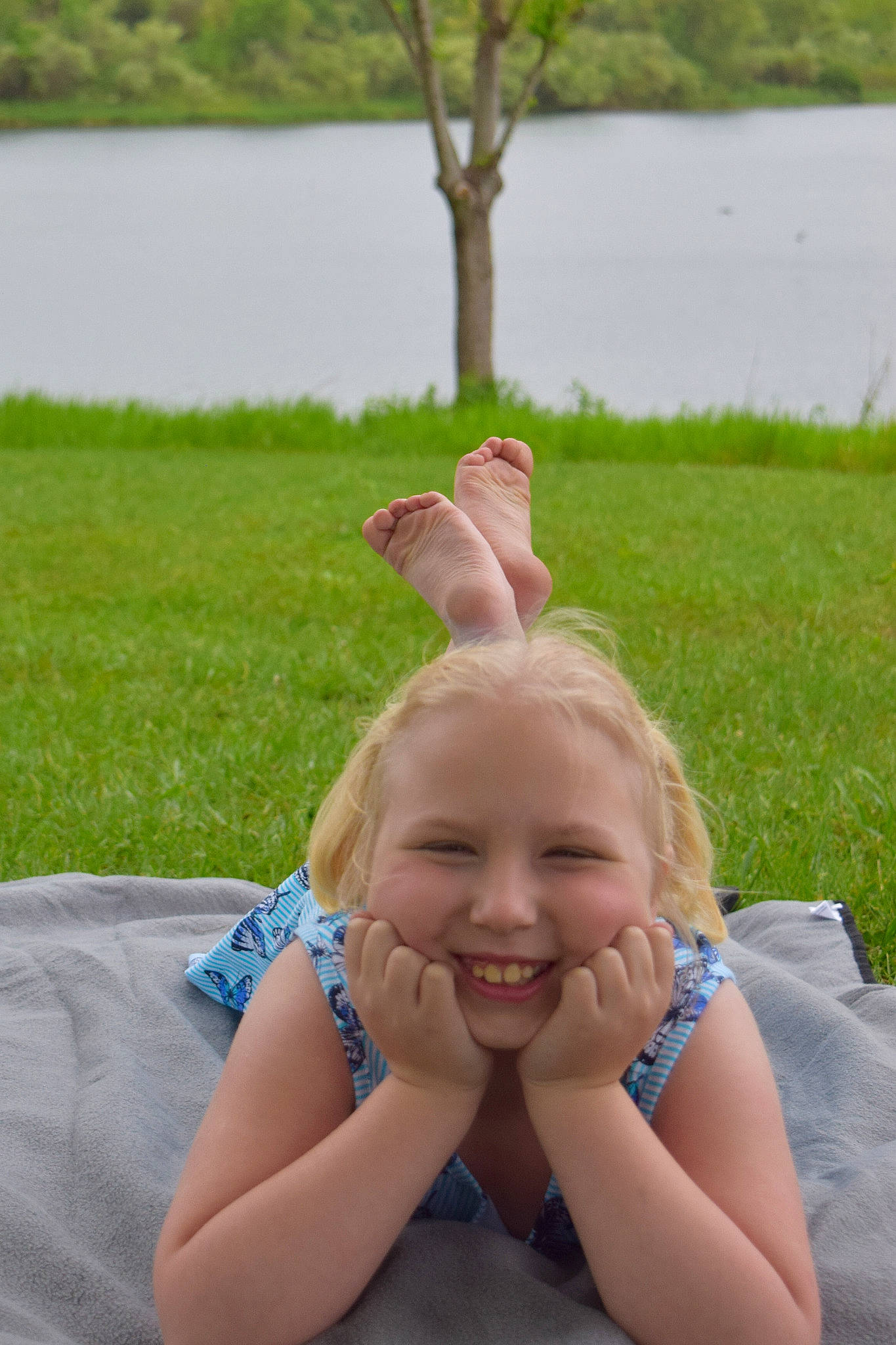 Kelsey joined the competition — help win amazing prizes! barefoot, blond, child, fun, grass, joy, leg, leisure, neck, person, sitting, smile, summer, vacation