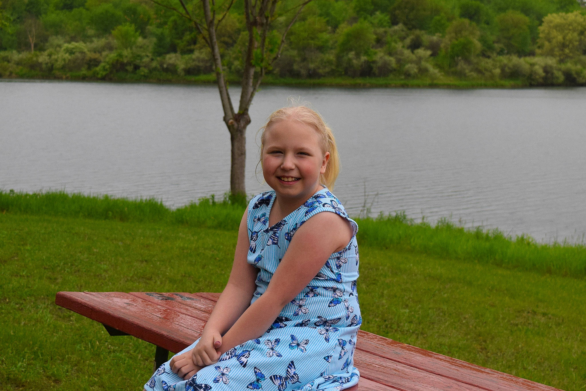 Kelsey joined the competition — help win amazing prizes! bank, child, fun, grass, happy, joy, lake, leisure, person, recreation, reservoir, sitting, smile, summer, tree, vacation, water