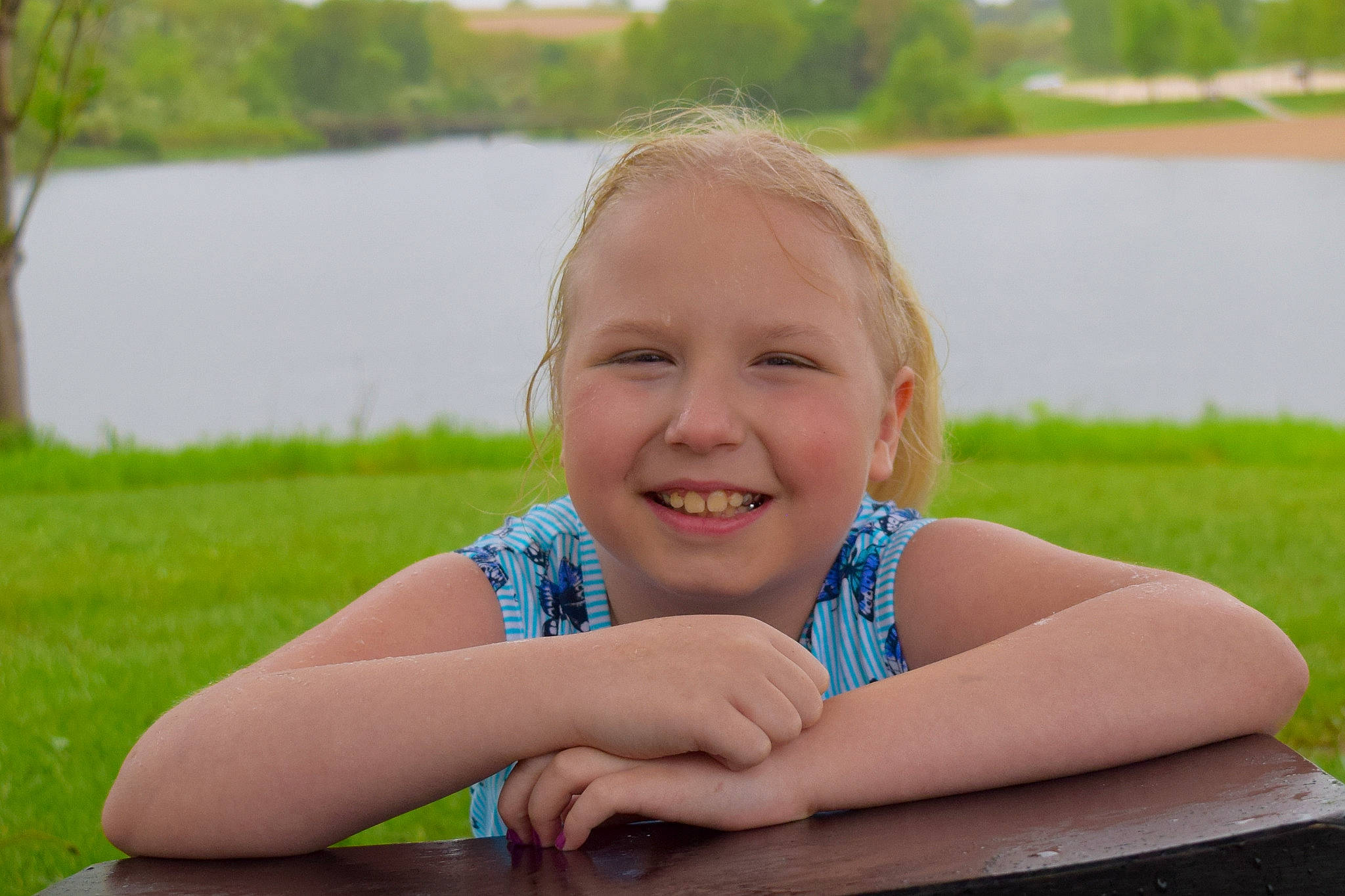 Kelsey is registered to the contest to win money with this photo: child, facial_expression, fun, grass, happy, joy, lawn, leisure, person, sitting, skin, smile, summer, toddler, vacation