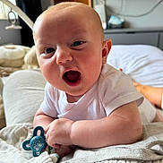 Harley joined the competition — help win amazing prizes! baby, infant, pacifier, white_clothing, bed, blanket, smiling, happy, face, indoors, toy, cute, skin, person, head, mouth_open, lying_down, soft_light, home, comfort