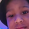 child, face, selfie, hat, indoor, lighting, blue_lights, portrait, young, casual, closeup, expression, person, headwear, smile, background, tree, led, purple_light, shirt