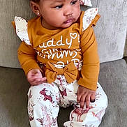 Kinsley is registered to the contest to win money with this photo: toddler, child, baby, sitting, couch, clothing, headband, mustard_yellow, floral, pants, long_sleeve, indoors, portrait, cute, baby_fashion, social_media, story, expression, face, feet