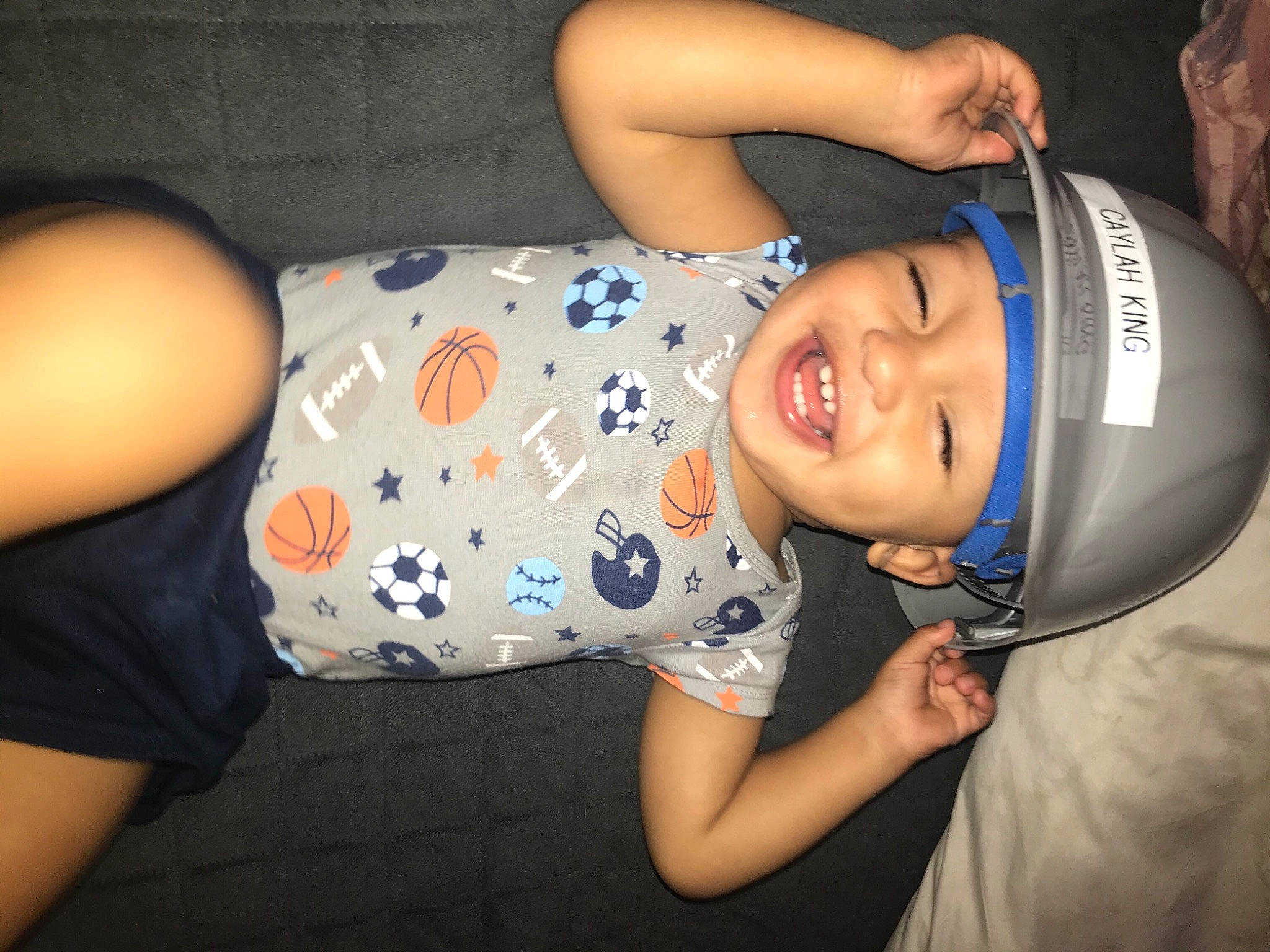 Gionni is registered to the contest to win money with this photo: arm, baby_toddler_clothing, cheek, cool, elbow, face, finger, flash_photography, fun, happy, headgear, headwear, human_body, human_leg, joy, mouth, person, skin, sleeve, smile