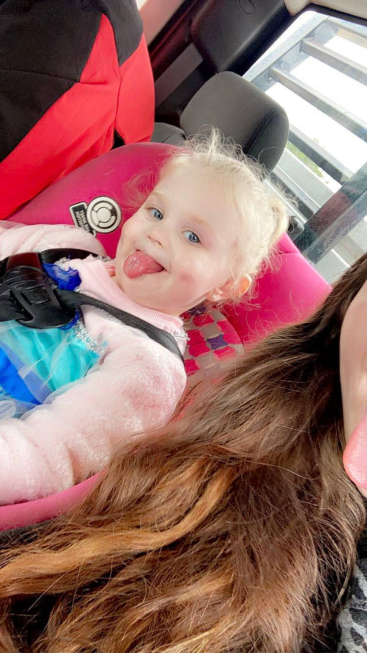 Annlee joined the competition — help win amazing prizes! baby, baby_products, blond, child, event, fashion_accessory, feathered_hair, fun, fur, happy, head, joy, leisure, magenta, person, pink, recreation, sitting, skin, smile