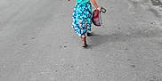 Cambrie is registered to the contest to win money with this photo: back_view, blue, casual, child, daytime, dress, footwear, greenery, hat, nature, outdoor, pattern, person, plastic_bag, road, rural, sidewalk, street, summer, walking