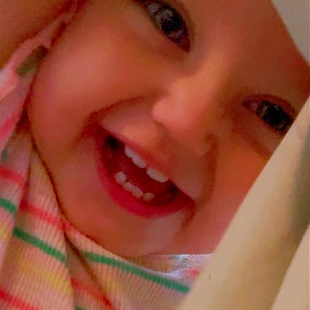 Alita is registered to the contest to win money with this photo: baby, cheeks, child, close_up, clothing, cute, expression, eyes, face, happy, infant, joyful, mouth, peeking, person, skin, smiling, striped, teeth, tongue