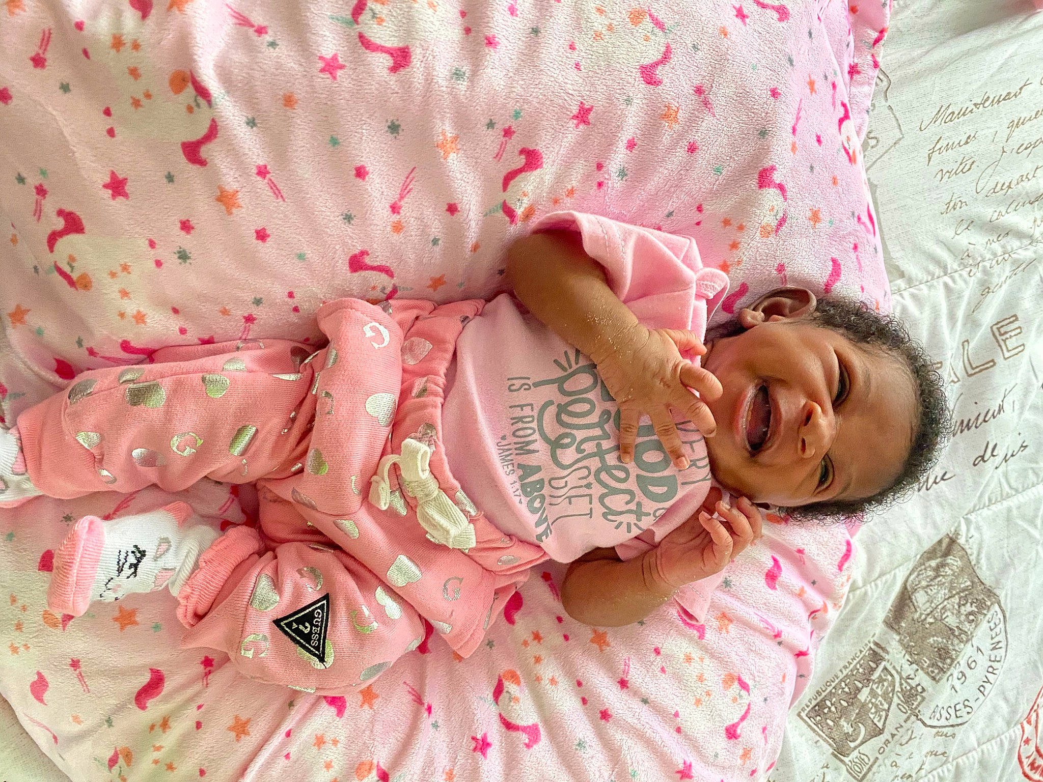 Dasia is registered to the contest to win money with this photo: baby, baby_toddler_clothing, bed_sheet, bedding, bedtime, blanket, cheek, child, hair_accessory, linens, peach, person, pink, skin, textile, toddler