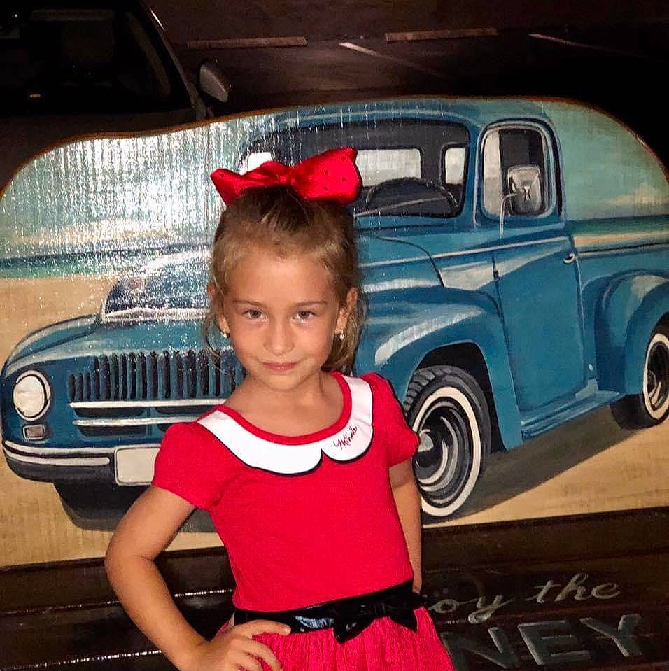 Alessia joined the competition — help win amazing prizes! automotive_design, automotive_exterior, automotive_lighting, automotive_tire, automotive_wheel_system, bumper, car, fender, grille, hood, joy, land_vehicle, motor_vehicle, person, photograph, pink, smile, tire, toy, vehicle