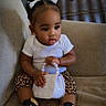 Zaneshia is registered to the contest to win money with this photo: baby, child, toddler, portrait, sitting, couch, indoors, hair_bows, white_shirt, leopard_print, sneakers, handbag, beads, fashion, cute, face, smiling, dark_hair, furniture, casual