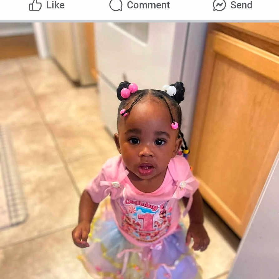 Zaneshia joined the competition — help win amazing prizes! appliance, birthday, cabinet, celebration, child, curious, girl, hair_buns, indoor, kitchen, looking_up, person, pink_shirt, portrait, screenshot, social_media, text_overlay, tile_floor, toddler, tutu