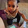 Zaneshia joined the competition — help win amazing prizes! toddler, child, baby, portrait, indoors, sitting, crouching, curious, face, eyes, hair_buns, hairstyle, ruffled_shirt, black_pants, carpet, comb, bottle, living_room, photograph, family