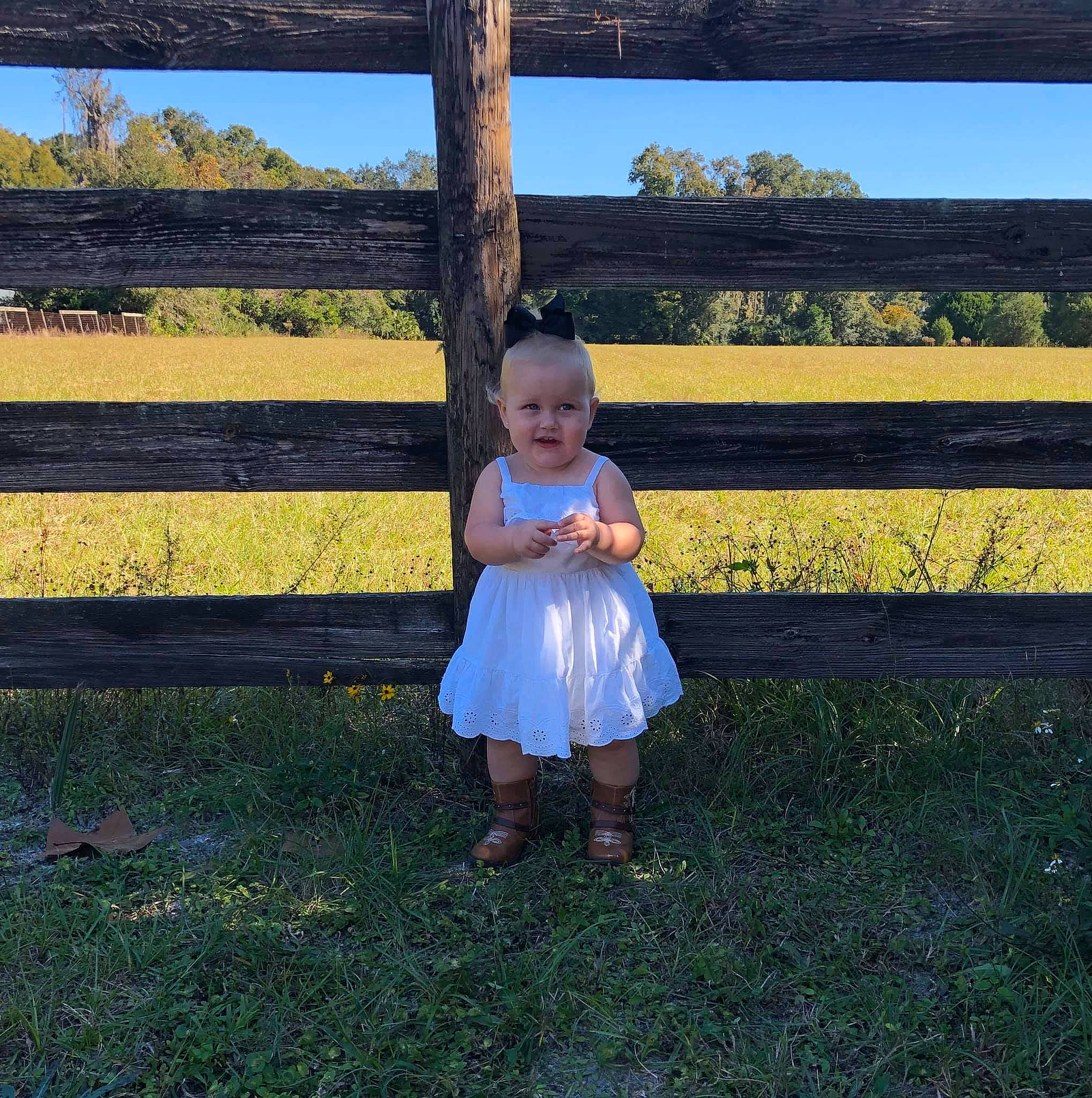 Kaylie is registered to the contest to win money with this photo: child, dress, grass, happy, meadow, person, photography, plant, sky, smile, spring, standing, summer, tree, trunk, vacation