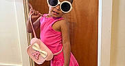 Arabella joined the competition — help win amazing prizes! child, girl, toddler, portrait, standing, posing, sunglasses, pink_outfit, dress, handbag, fashion, smiling, indoors, wooden_door, wood_floor, hair_bows, sandals, accessories, fashionable, full_body