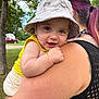 adult, arm, baby, bucket_hat, child, grass, happy, hat, mesh_top, outdoor, park, person, pink_hair, shoulder, smile, summer, sunlight, tattoo, tree, vehicle
