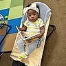 baby, baby_chair, book, bow, carpet, child, clothing, cute, engaged, expression, feet, headband, indoor, infant, lemon_pattern, person, play_mat, reading, socks, toy