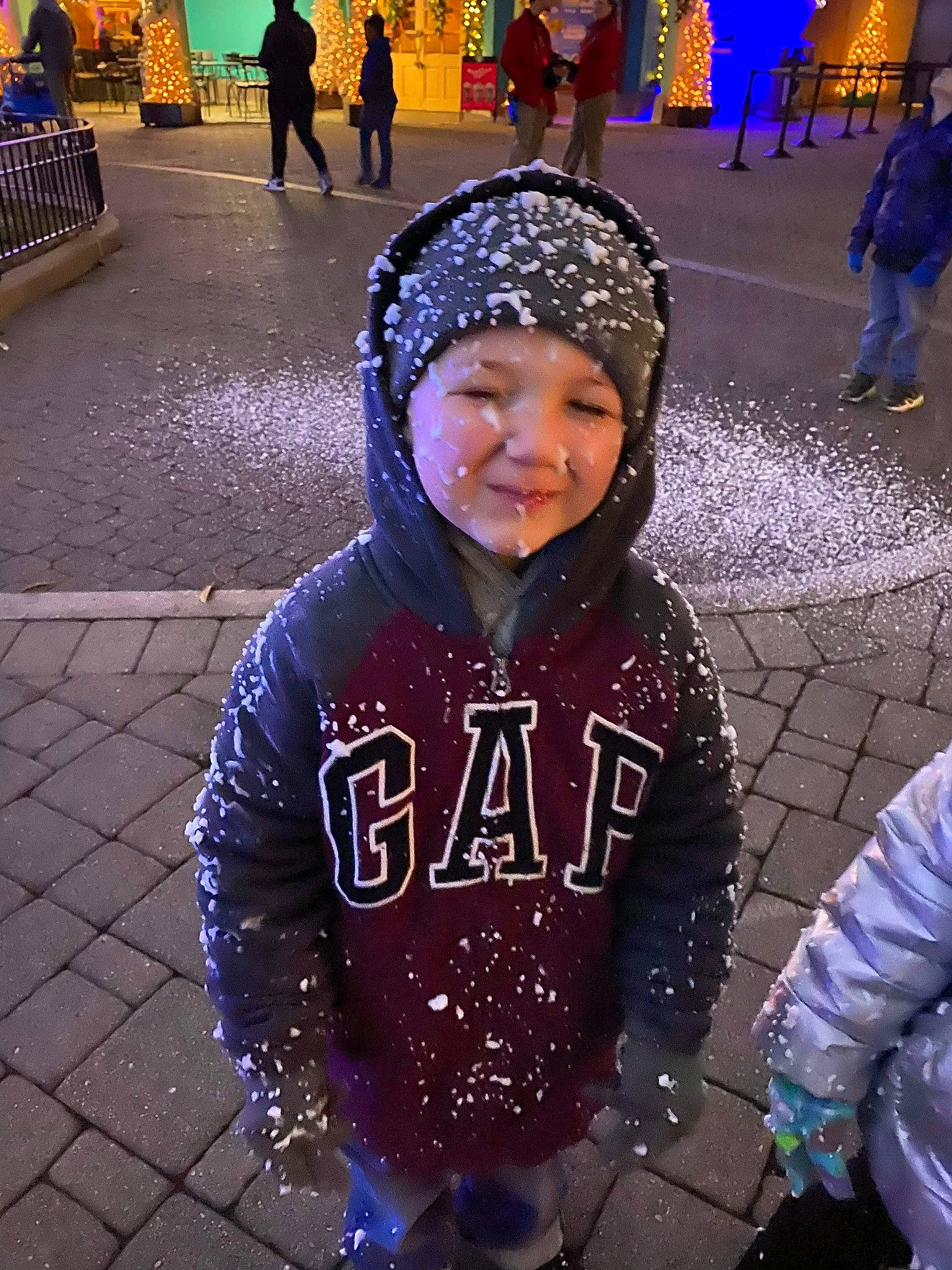 Drew is registered to the contest to win money with this photo: child, cool, crowd, fun, headgear, headwear, human, outerwear, people, person, purple, smile, snow, winter
