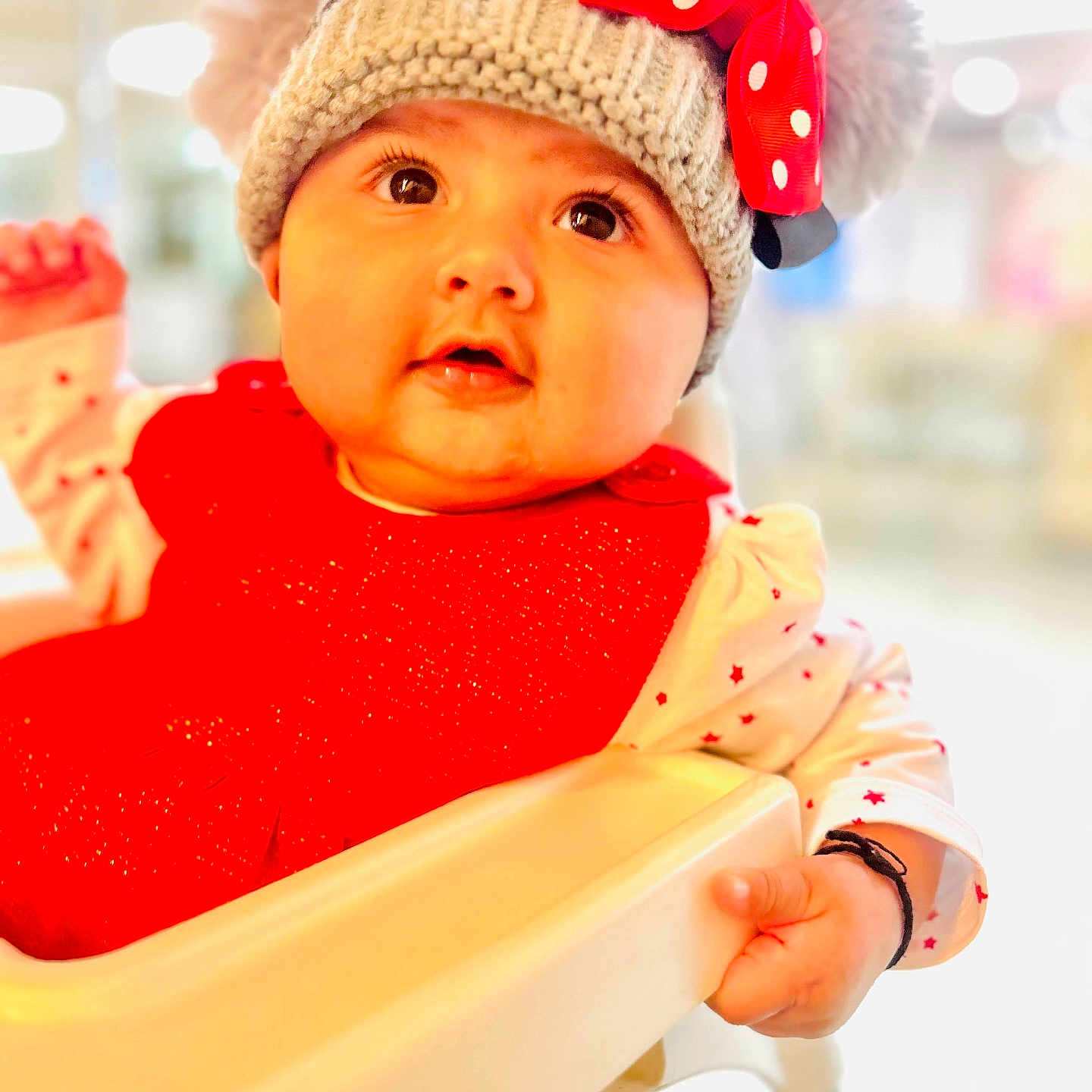 Sia is registered to the contest to win money with this photo: baby, beanie, bodypart, bonnet, cap, chair, clothing, face, finger, frown, furniture, hand, happy, hat, head, newborn, person, photography, portrait, smile