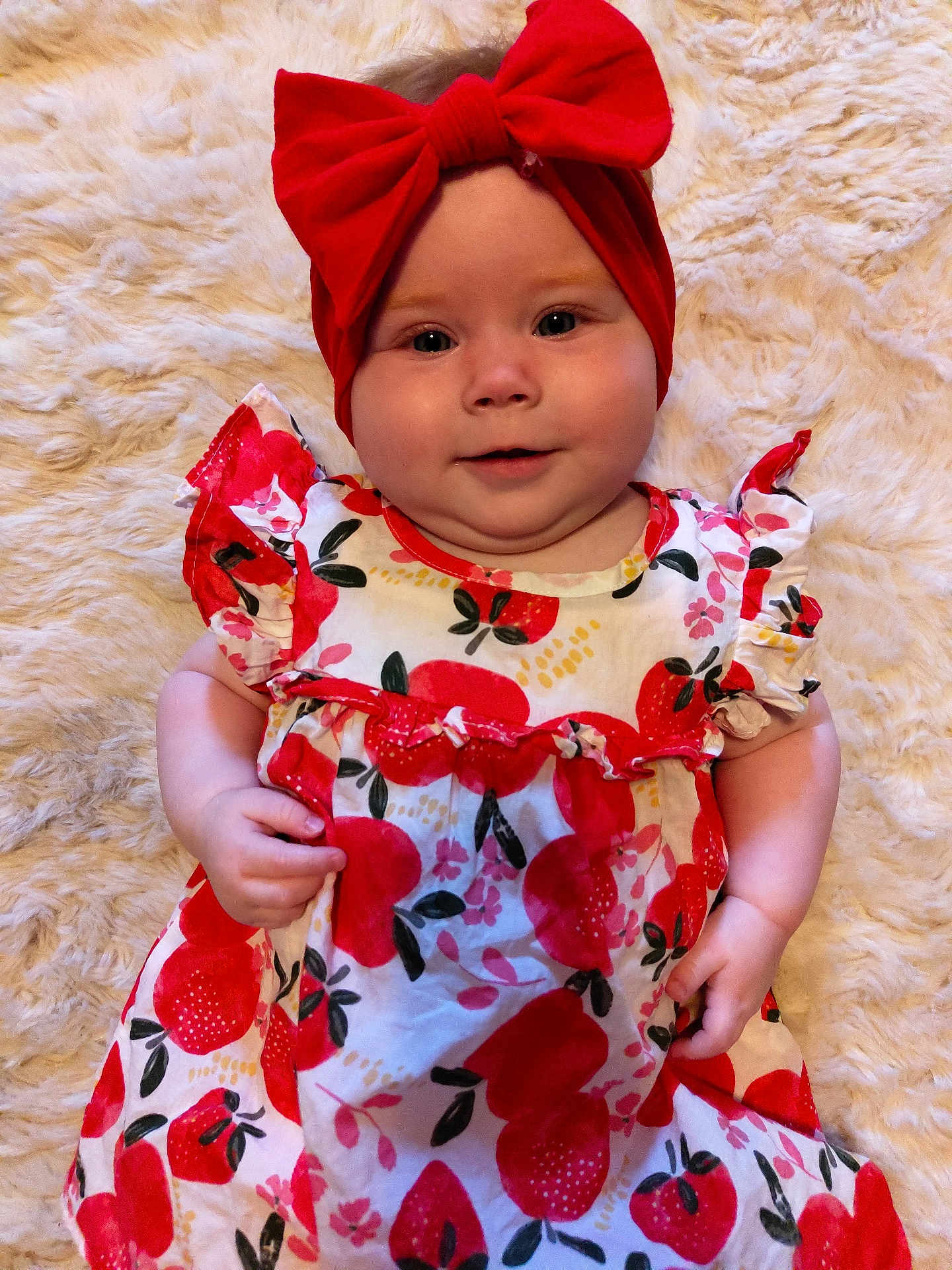 Violet Ann is registered to the contest to win money with this photo: baby, child, red_bow, headband, apple_print, dress, fluffy_blanket, smile, cute, infant, portrait, closeup, indoors, soft_texture, happy, chubby_cheeks, person, fashion, colorful, playful