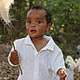 Khalil joined the competition — help win amazing prizes! toddler, child, outdoor, forest, greenery, white_clothing, curly_hair, feather, stick, nature, portrait, young_child, expression, summer, daylight, person, leaves, background_blur, cute, exploring