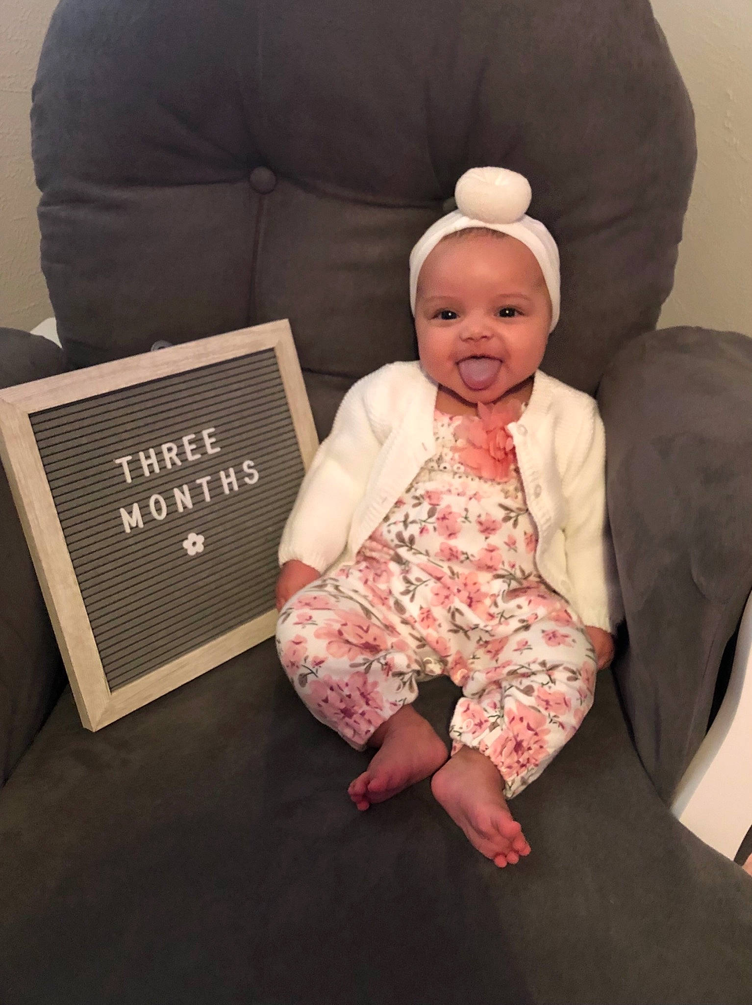 Charli Janae joined the competition — help win amazing prizes! baby, baby_toddler_clothing, cap, child, comfort, finger, flooring, foot, happy, lap, linens, person, pillow, room, sitting, sleeve, smile, sock, t_shirt, throw_pillow