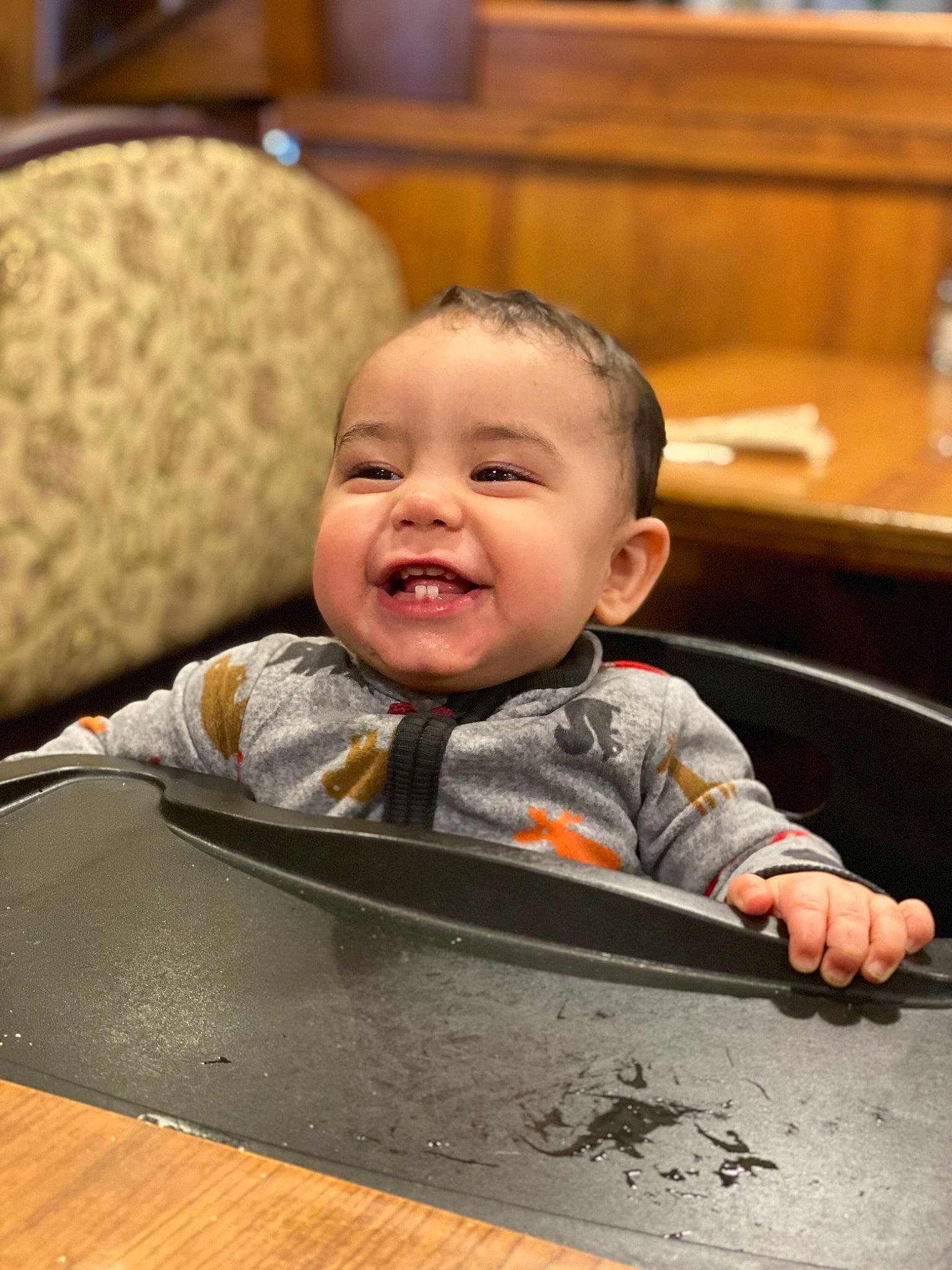 Andre is registered to the contest to win money with this photo: baby, baby_laughing, baby_toddler_clothing, bottle, chair, cheek, child, comfort, facial_expression, flooring, fun, happy, hardwood, head, person, sitting, skin, smile, table, toddler