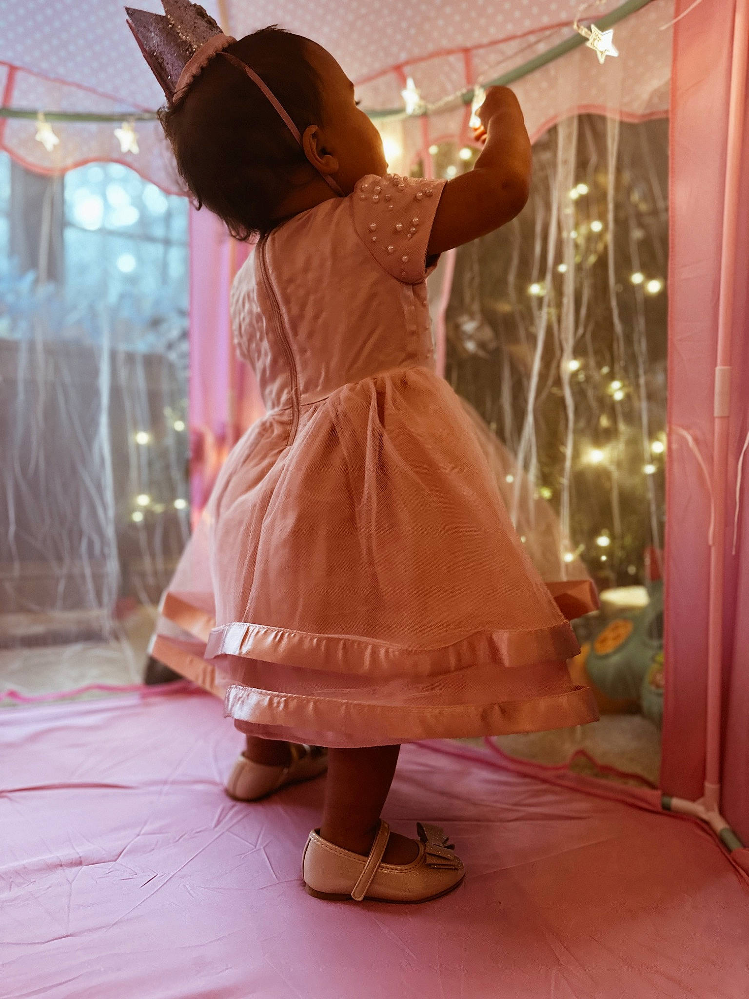 Sadie is registered to the contest to win money with this photo: costume, dress, entertainment, event, fashion_accessory, fashion_design, flooring, fun, hat, human_leg, magenta, one_piece_garment, peach, performing_arts, person, pink, room, sandal, sleeve, toddler