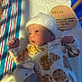 Remy joined the competition — help win amazing prizes! newborn, baby, crib, plush_toy, onesie, knitted_hat, blanket, soft_toy, wooden_sign, infant, cute, sleepwear, baby_clothes, lying_down, bed, peaceful, indoor, portrait, child, resting