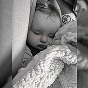 Laïa participe au concours pour gagner de l'argent avec cette photo : baby, sleeping, blanket, car_seat, child, cozy, monochrome, soft_texture, peaceful, face, head, clothing, indoors, comfort, portrait, closeup, infant, wrapped, cuddly, resting
