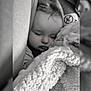 baby, sleeping, blanket, car_seat, child, cozy, monochrome, soft_texture, peaceful, face, head, clothing, indoors, comfort, portrait, closeup, infant, wrapped, cuddly, resting
