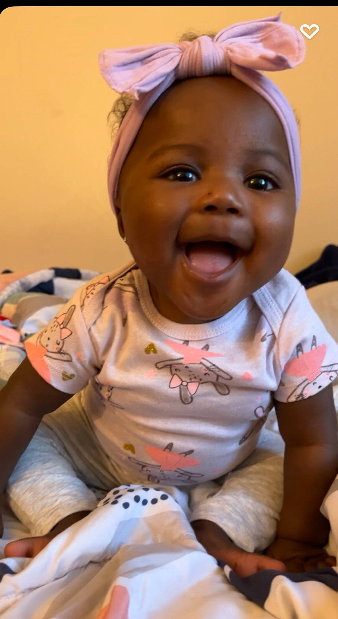 Braylynn is registered to the contest to win money with this photo: arm, baby_toddler_clothing, cheek, chin, dress, eye, face, facial_expression, finger, gesture, hairstyle, happy, head, iris, lip, mouth, nose, person, pink, skin