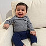 Faisal joined the competition — help win amazing prizes! baby, child, comfortable, couch, cozy, cute, furniture, happy, home, indoor, infant, navy_pants, person, portrait, sitting, smile, striped_shirt, toddler, white_socks, young_child