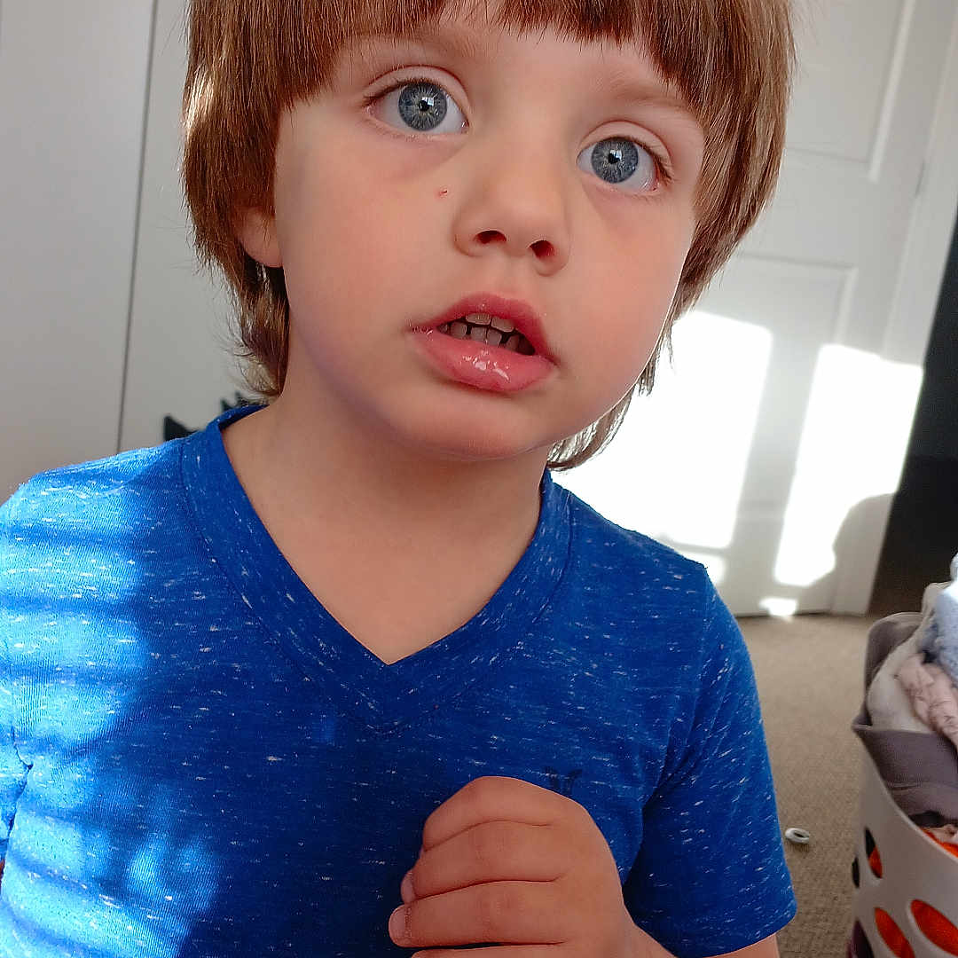 Sean is registered to the contest to win money with this photo: baby, bodypart, clothing, couch, dress, face, finger, furniture, hair, hand, head, knitwear, longsleeve, mouth, person, photography, portrait, sleeve, sweater, t_shirt