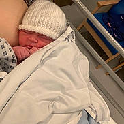 Adalynne joined the competition — help win amazing prizes! newborn, baby, infant, hospital, blanket, hat, sleeping, bed, bassinet, clothing, person, indoor, rest, cozy, cute, child, healthcare, quiet, peaceful, family