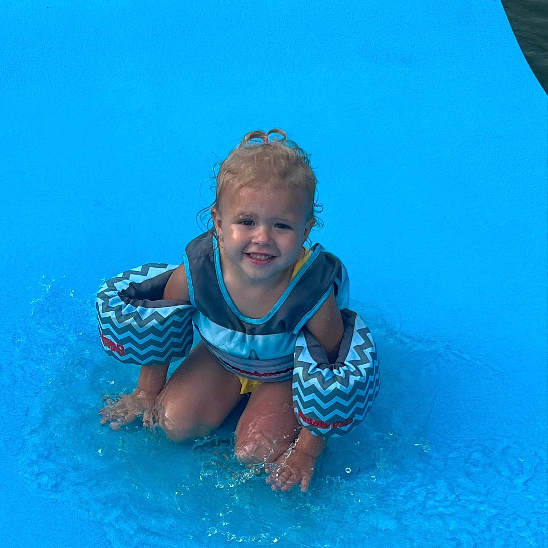 Alice is registered to the contest to win money with this photo: amusementpark, baby, clothing, face, head, leisureactivities, lifejacket, person, photography, pool, portrait, shorts, sport, summer, swimming, swimmingpool, swimwear, vest, water, watersports