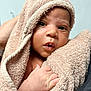 baby, infant, towel, wrapped, hand, skin, face, eyes, mouth, newborn, cute, soft, warm, person, portrait, closeup, indoor, expression, child, family