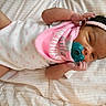 Mi'Angel joined the competition — help win amazing prizes! baby, infant, child, portrait, lying_down, pacifier, headband, pink_clothing, onesie, bed, blanket, quilt, indoor, sleeping, awake, face, hands, dark_hair, cute, photography
