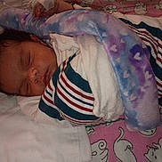 Mi'Angel is registered to the contest to win money with this photo: newborn, baby, sleeping, infant, face, blanket, swaddle, pacifier, bed, bedding, pink, purple, striped_clothing, cat_pattern, cozy, indoors, portrait, napping, peaceful, child