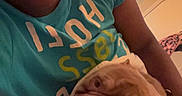 Tank Carter is registered to the contest to win money with this photo: bed, blanket, bulldog, casual, comfort, dog, door, face, furniture, headwear, indoor, lamp, person, puppy, resting, selfie, smile, tshirt, warm_lighting, window