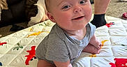 Nicholas is registered to the contest to win money with this photo: baby, infant, smiling, play_mat, dog, couch, person, legs, home, indoor, cute, child, happy, sitting, shorts, carpet, animal, pet, human, casual