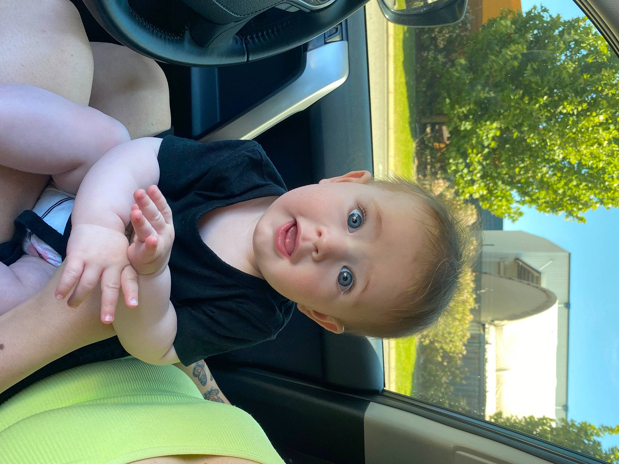Kyan is registered to the contest to win money with this photo: auto_part, automotive_exterior, baby, child, elbow, finger, fun, gesture, grass, green, leisure, motor_vehicle, person, sky, smile, surprise, toddler, tree, vehicle_door, white