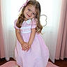 child, girl, pink_dress, bow, smile, sitting, stool, curtains, window, indoors, carpet, happy, cute, portrait, person, long_hair, white_shoes, floor, home, young