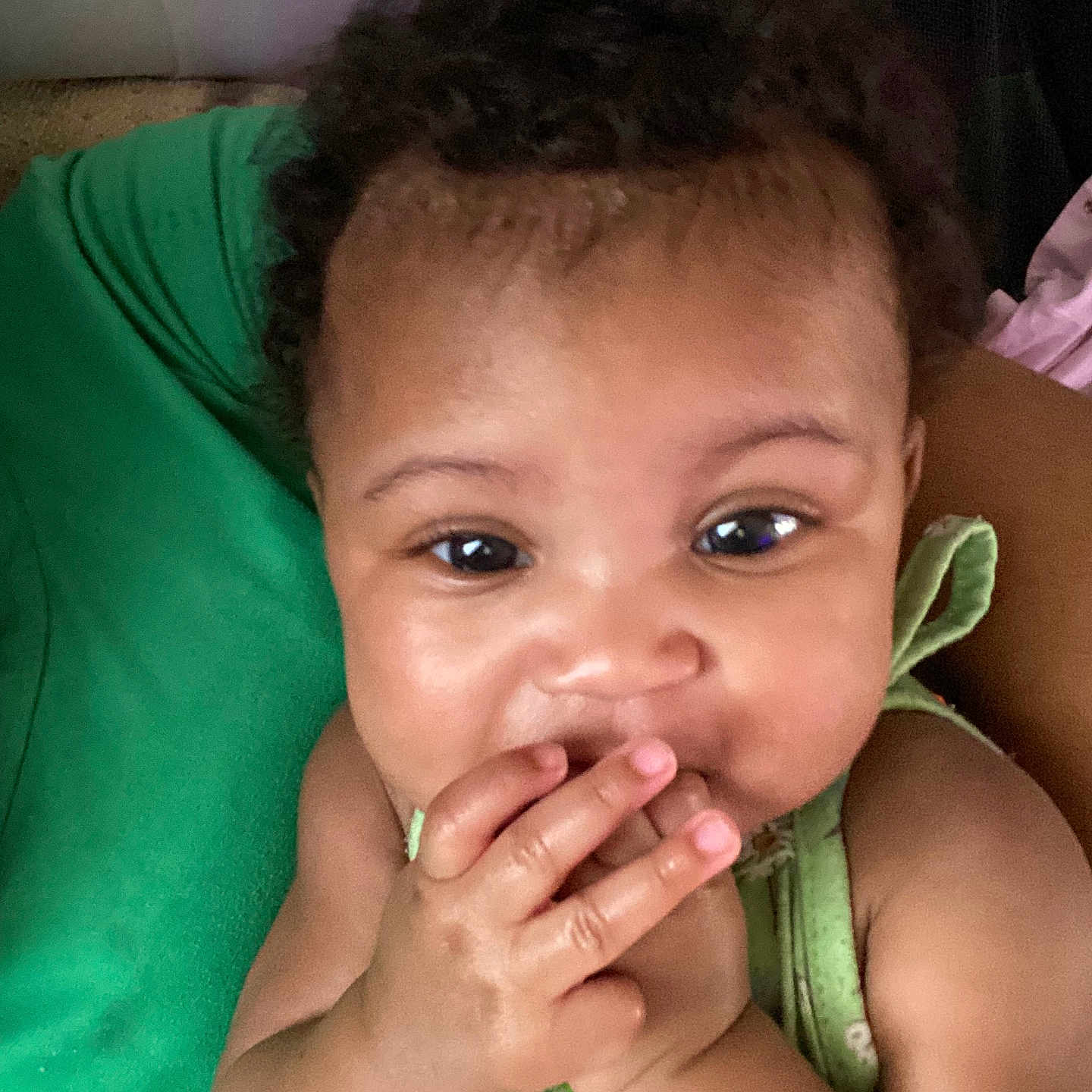 Avery joined the competition — help win amazing prizes! baby, child, close_up, curly_hair, cute, expression, eyes, face, fingers, green_clothing, hand, indoors, infant, person, playful, portrait, resting, skin, smiling, young